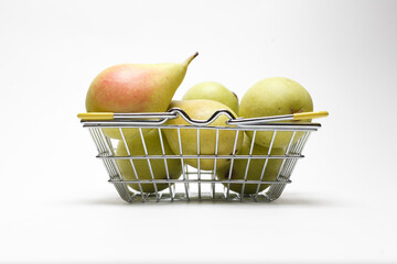Pear in grocery basket isolated on white background