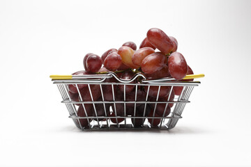 Grapes in grocery basket isolated on white background