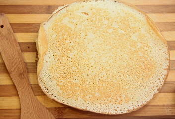 Stack of homemade pancakes on wood cooking board