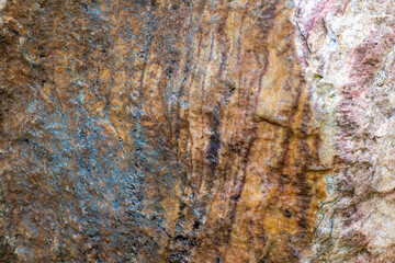 The shiny, orange surface of the cave stone,