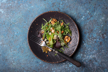 Healthy vegetarian salad with mix of fresh green leaves, blue cheese and nuts
