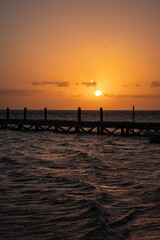 Fototapeta premium Beautiful sunset over a pier in Holbox, Mexico. Holbox sunset. 