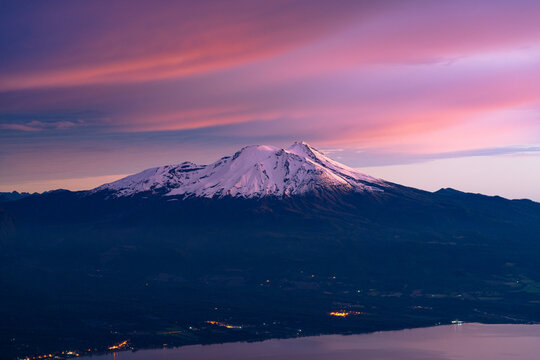showing colors in the clouds and the snow top of calbuco volcano, after the sunset. blue hour