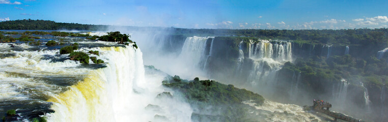 Fototapeta premium Panoramic photograph of the Iguaçu Falls. Showing the waterfalls and blue sky.
