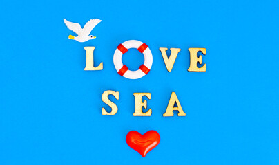 LOVE SEA lettering with a seagull, lifebuoy and a red heart symbol on blue