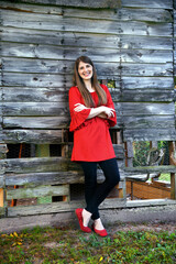 Barn Serves as Backrest for Young Woman