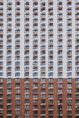 Fototapeta na wymiar Modern architecture facade high rise multi storey residential building front view.