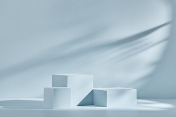 Blue background for product presentation with shadows and light. Empty podiums. Mockup.