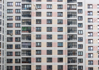 Fototapeta na wymiar Modern architecture facade high rise multi storey residential building front view.