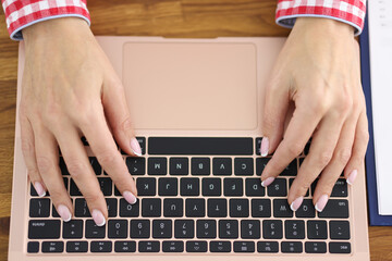 Fototapeta na wymiar Female hands are typing on laptop keyboard.