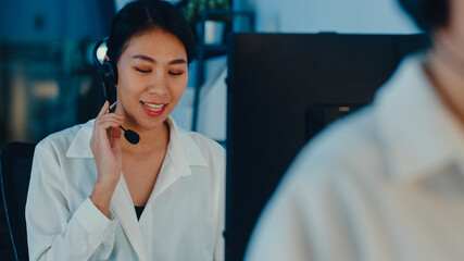 Millennial Asia young call center team or customer support service executive using computer and...