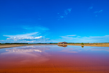 Salt barn with blue sky background in salt fields at Bang Tabun city of Petchaburi province, Thailand