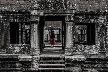 Fototapeta na wymiar Woman with Red Dress at an Ancient Asian Temple 