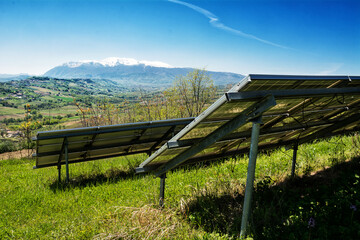 Detail of a solar panel system overlooking the mountains and nature