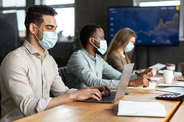 Colleagues having meeting in boardroom, working on a project