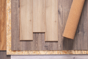 Naklejka na ściany i meble Laminate floor and cork roll on wood osb background texture. Wooden laminate floor and chipboard
