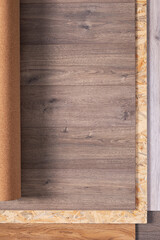 Laminate floor and cork roll on wood osb background texture. Wooden laminate floor and chipboard