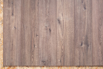 Laminate floor on wood osb background texture. Wooden laminate floor and chipboard background