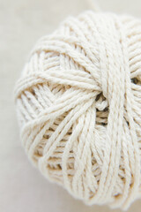 
Ball of white woolen threads, close-up, top view. Sewing and needlework concept. Macro. Selective focus.