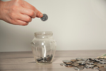 woman hand holding piggy bank and coin