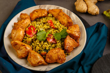 Food for suhoor in Ramadan bulgur fast with beef in a plate on a blue napkin next to vegetables.