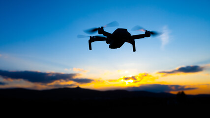 Fototapeta na wymiar Drone silhouette at sunset time