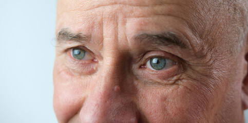 close-up of face old man, senior with deep wrinkles, cheerful gray eyes laugh, concept human...
