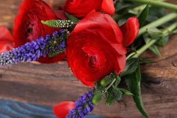 Red ranunculus on wooden board