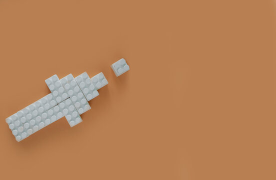 White Computer Cursor Or Directional Arrow Made Of Blocksand Building Parts On A Neutral Beige Background
