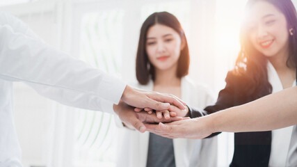 Blurly of volunteer hand stack people to show teamwork spirit togetherness, Group of people participation of charity.