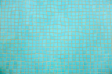 view of the blue pool floor through distorted water. pool background