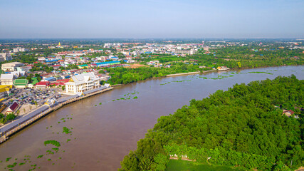 Fototapeta na wymiar Aerial view of community, temple and building along the Bang Pakong river in Chachoengsao province, Thailand.