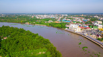 Aerial view of community, temple and building along the Bang Pakong river in Chachoengsao province, Thailand.