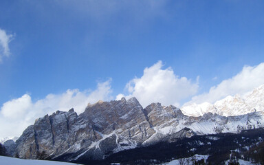 A landscape and cloudscape of the astonishing Italian Alps after a big snowfall.