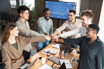 Portrait of smiling diverse business people giving fist bump