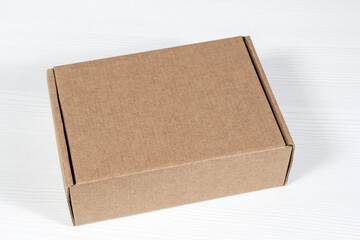 A brown gift box lies on a white background