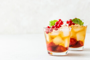 Summer party cocktail, berry iced tea in glasses. Space fot text.