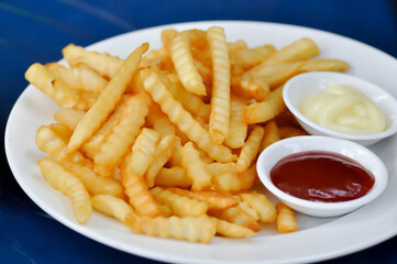 French fries or fried potato with tomato sauce and mayonnaise