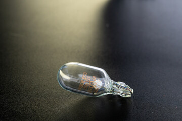 Ukraine, Khmelnytskyi - 4 may 2021: Bosh halogen bulb. Filament. Black background. Close-up view....