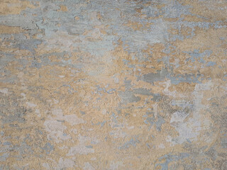 Fototapeta na wymiar Peeling and cracked wall of an old house, light beige tone background