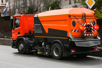 Cleaning machine washes asphalt road surface the city street