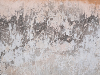 Peeling and cracked wall of an old house, grunge background