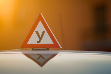Car with driving school sign on roof. Driving school concept, driver's license, traffic rules....