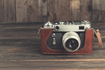 Vintage camera on wooden background, with vintage color tone. 