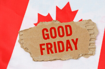 Against the background of the flag of Canada lies cardboard with the inscription - Good Friday