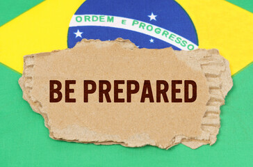 Against the background of the flag of Brazil lies cardboard with the inscription - Be Prepared