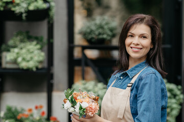 Fototapeta premium Modern small business with plants in city outdoor, owner and seller at work