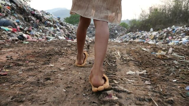 Poor Feet Kid Walking, Garbage At Background, Slow Motion 96Fr/S.
