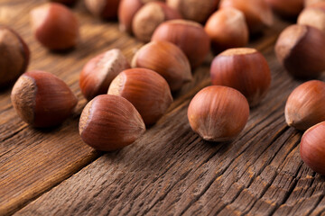Whole young hazelnuts on a wooden table. Hazelnut tree and hazelnuts. A scattering of hazelnuts.