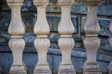 Fototapeta na wymiar Antique marble pillars hold the railing. Decorative element of the railing in the castle, marble balusters.
